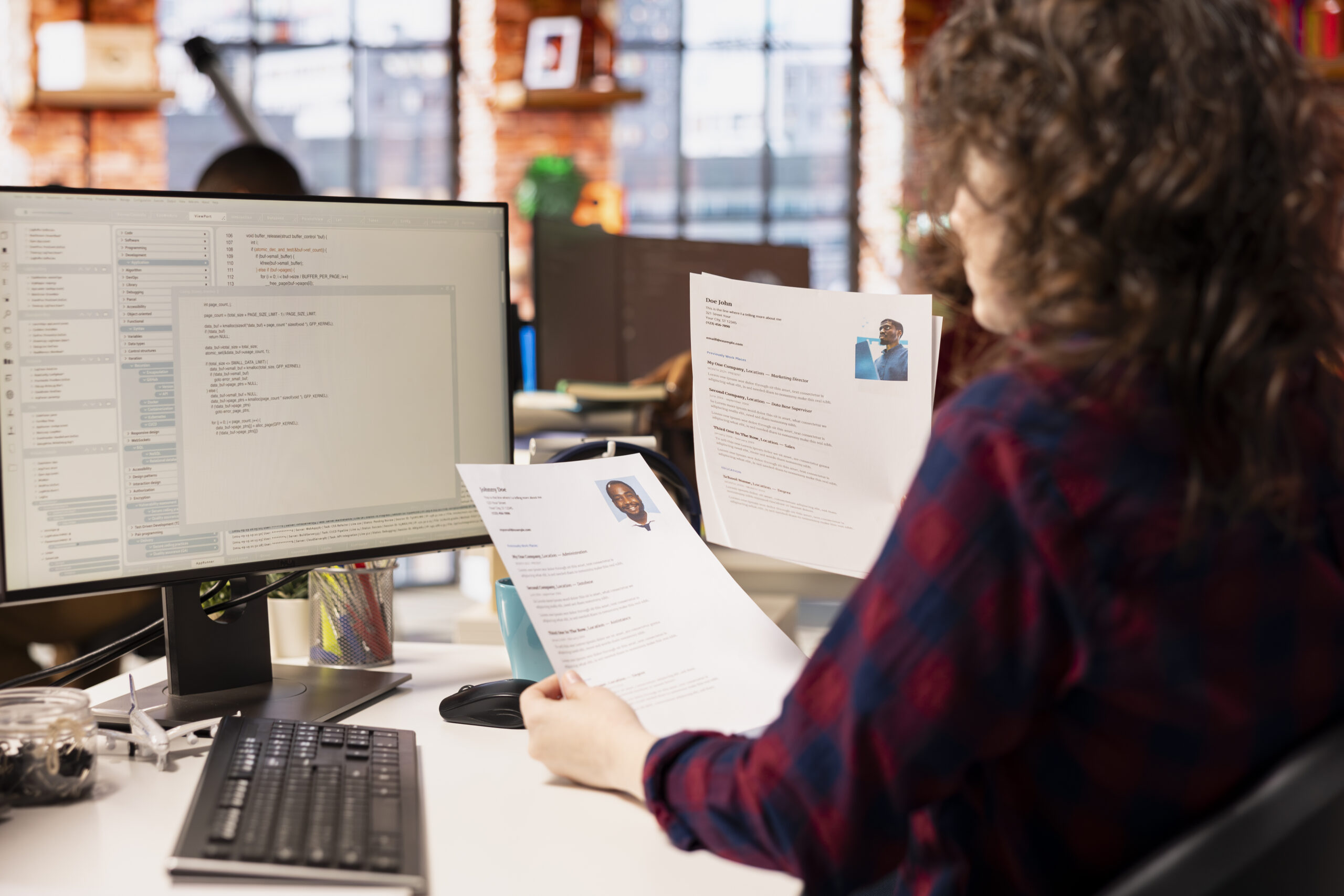 Startup HR worker identifying right candidates for job opening, reviewing resumes to determine qualifications. Woman doing screening process, selecting skilled people for software development position